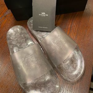 BRAND NEW IN BOX. Coach Ulyssa rubber slides in silver.  Never worn. Size 11